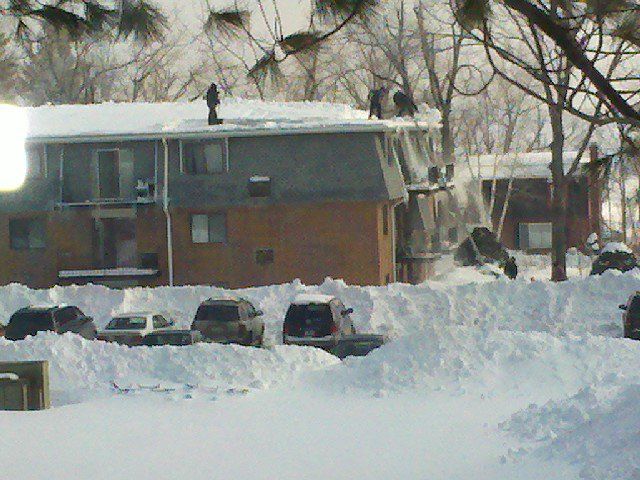 Shoveling_a_snowy_roof_Doesn_t_look_fun_at_all